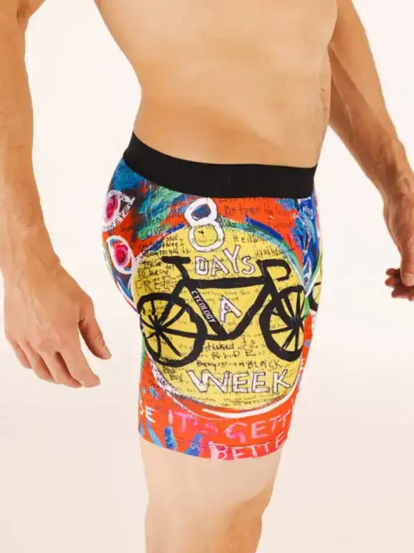 Men's cycling shorts with colorful '8 Days a Week' bike graphic design, vibrant print, black waistband