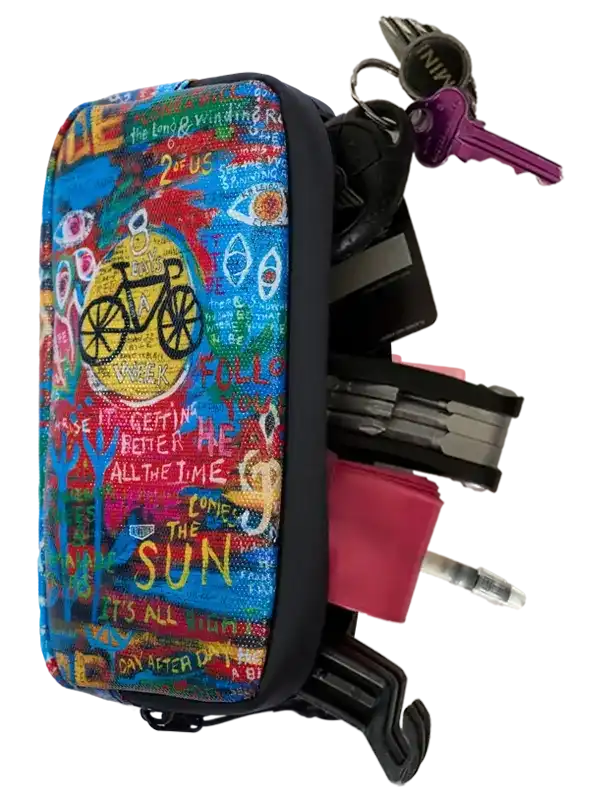 Colorful cycling accessory pouch with bike graphic, holding keys and tools for riders