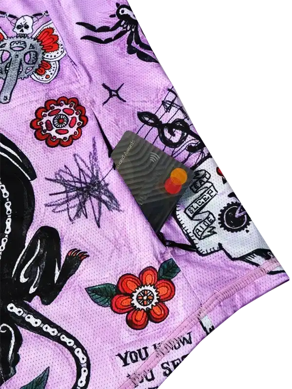 Purple cycling shorts with bold floral and skull designs, ideal for men's and women's rides.