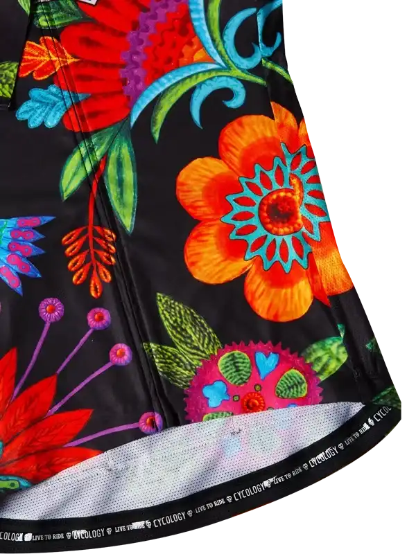 Vibrant floral cycling jersey with bold orange, red, and teal flowers on black fabric, featuring mesh hem and 'Cycology' branding.