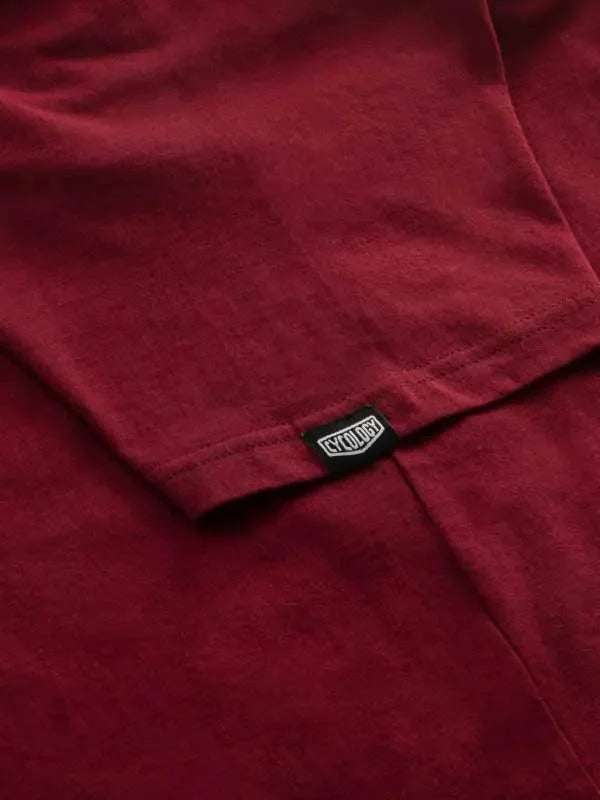 Deep red cycling jersey with black brand tag, soft fabric detail for men's and women's rides
