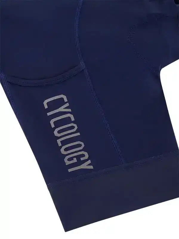 Navy blue cycling shorts with 'CYCOLOGY' logo, featuring ergonomic seams and pocket detail for comfort and performance.
