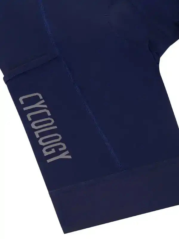 Navy blue cycling shorts with 'CYCOLOGY' logo, high-quality fabric for men's and women's bike wear