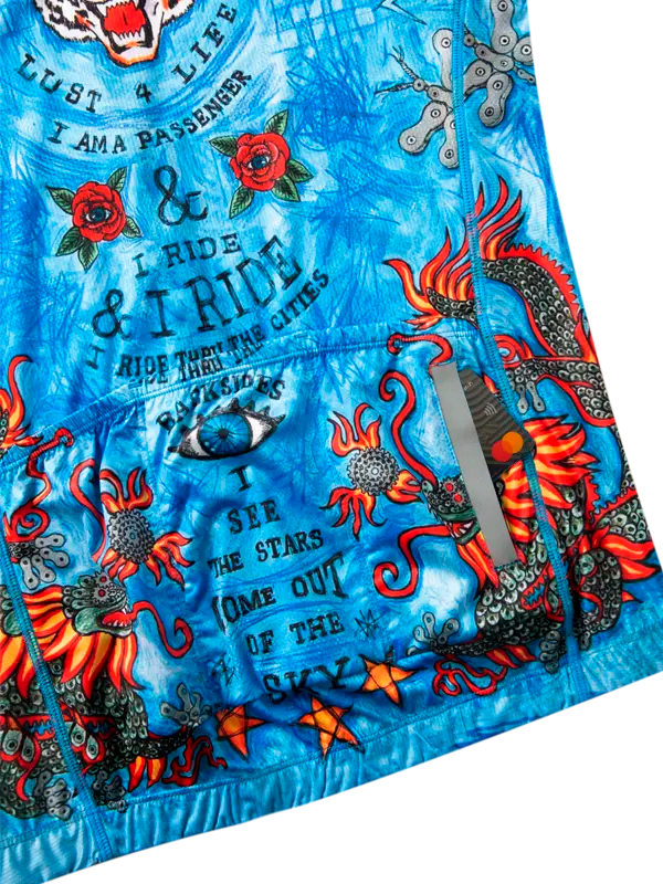 Blue cycling jersey with colorful graphic design with dragons, stars, and text and Cycology brand
