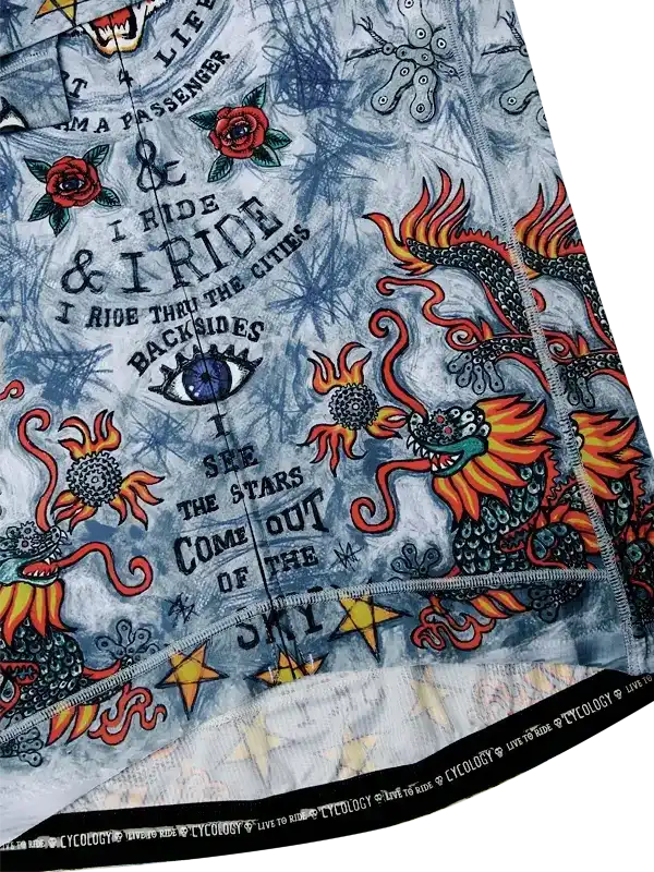 Men's cycling jersey with dragon, roses, and tattoo-style graphics on light blue fabric