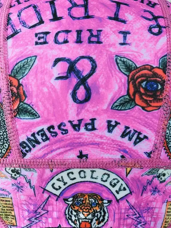 Pink cycling cap with 'I RIDE' text, roses, tiger graphic, and tattoo-style design for bike enthusiasts