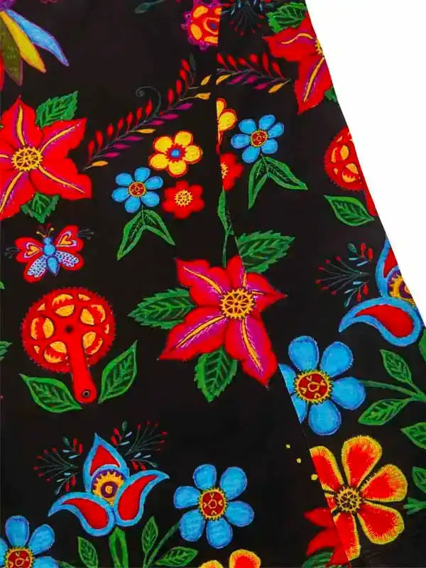 Vibrant floral and butterfly print on black cycling fabric, featuring bold red, blue, and yellow designs.