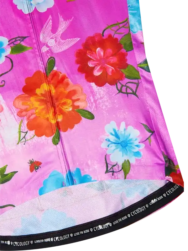 Vibrant floral cycling jersey with pink, orange, and blue blooms, ideal for women's cycling wear.