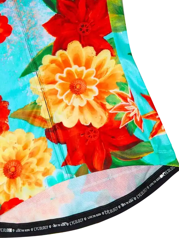 Vibrant floral cycling jersey with red and yellow blooms on turquoise background, featuring breathable mesh hem.