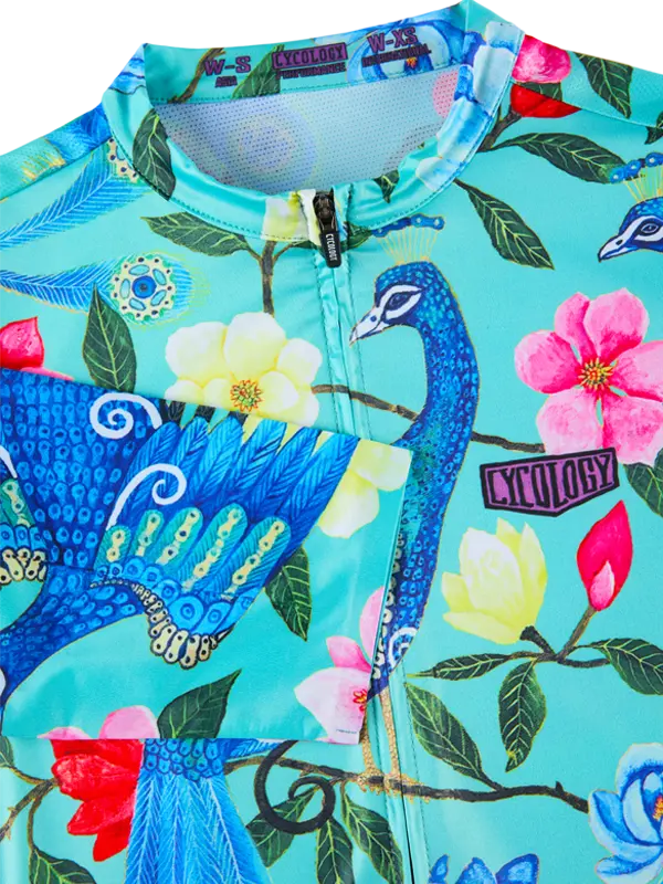 colorful floral  cycling jersey with peacock and floral design on a turquoise background
