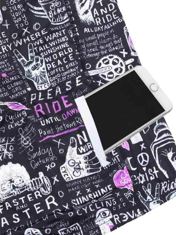 Black cycling shorts with white and purple graffiti-style bike culture print, featuring phrases like 'RIDE' and 'PEACE'