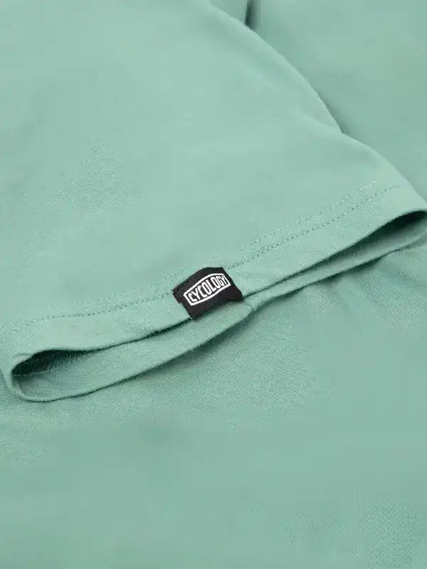 Mint green cycling jersey sleeve with CYCOLOGY tag, soft fabric detail for men's and women's bike wear