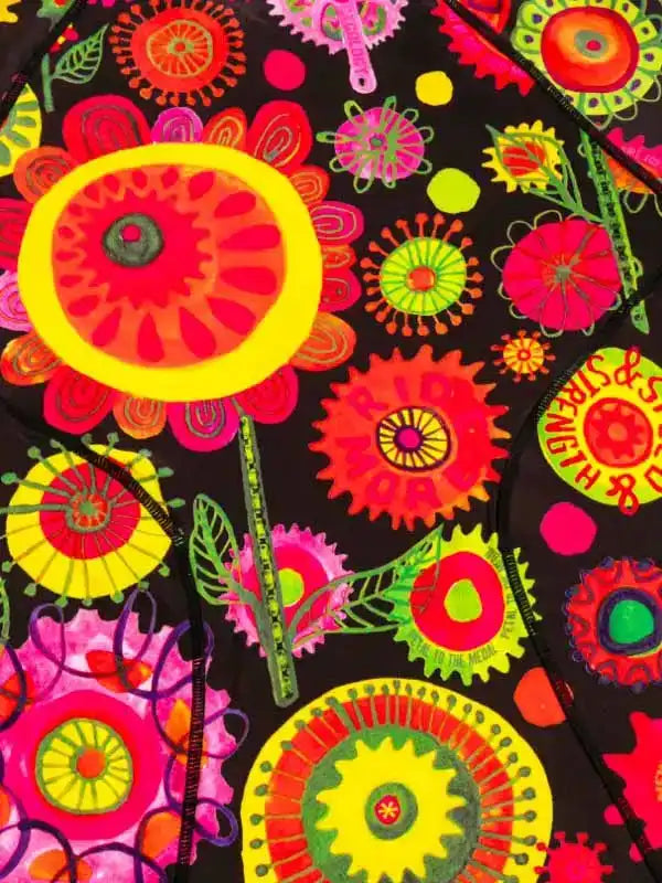 Vibrant floral and gear print cycling jersey with bold neon colors and 'RIDE MORE' text