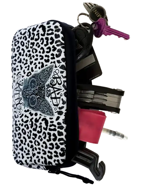 Leopard print cycling key pouch with cat design, holding keys and tools