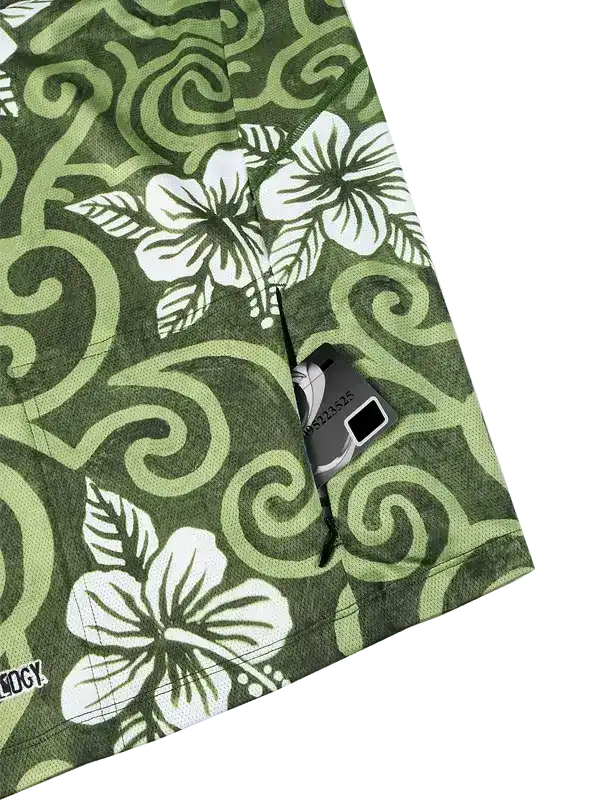 Green cycling shorts with white hibiscus flowers and swirl patterns, featuring a zippered pocket for storage.