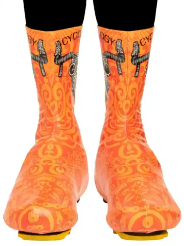 Orange cycling shoe covers with bold patterns and bike graphics for men's and women's rides