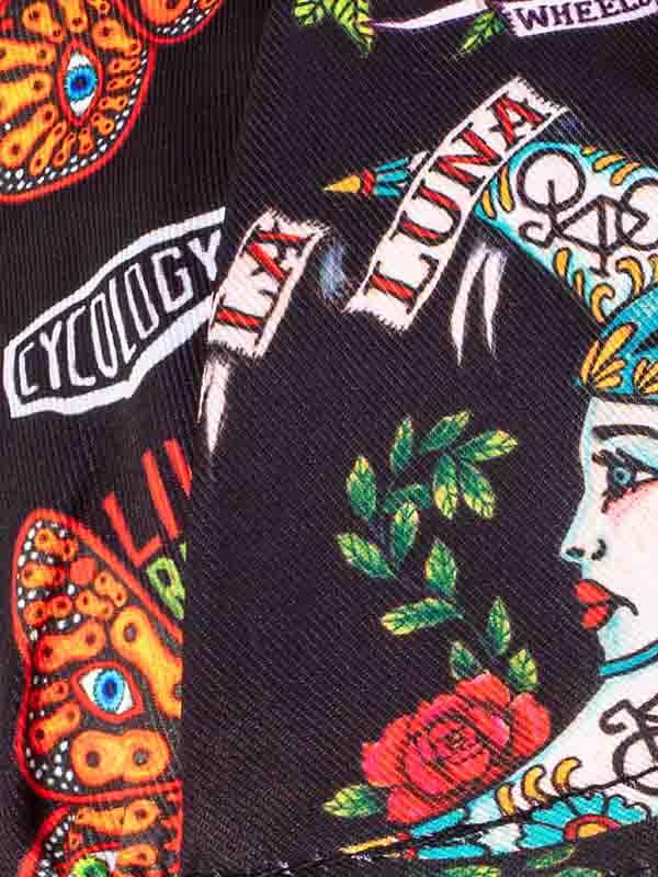 Vibrant tattoo-style cycling apparel with bold designs, roses, and 'LUNA' text on dark fabric.