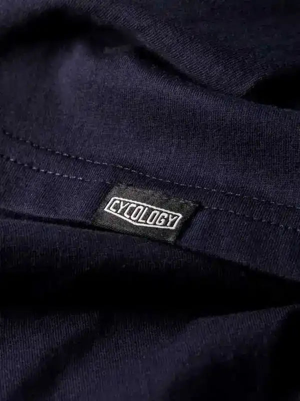 Cycology brand tag on dark navy cycling apparel, showcasing quality fabric and design detail
