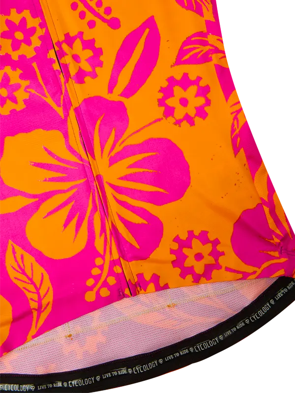 Close-up of a vibrant orange and pink floral patterned fabric with 'cycology' branding.