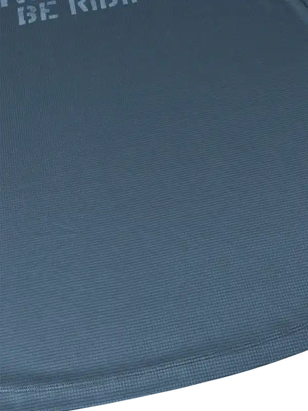 Blue cycling jersey with textured fabric and partial 'BE RIDE' text, showcasing breathable performance wear.