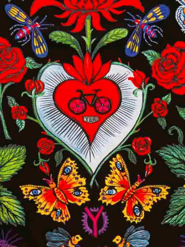 Vibrant cycling-themed embroidery with red heart, bike, roses, and butterflies on dark fabric