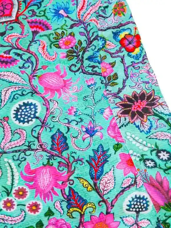 Vibrant floral cycling jersey with pink, blue, and teal botanical print on breathable fabric