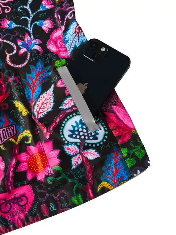 Vibrant floral cycling shorts with phone pocket, featuring bold pink, blue, and green patterns for women's bike wear.
