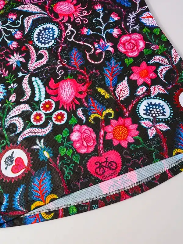 Vibrant floral cycling shorts with pink roses, blue accents, and bike motifs on black fabric