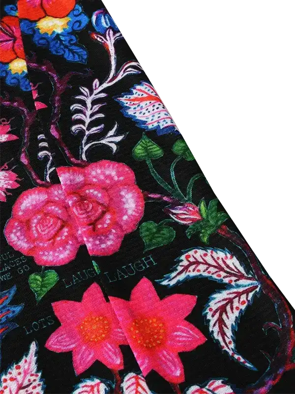 Vibrant floral cycling apparel with pink roses and green leaves on black fabric