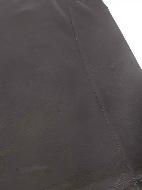 Close-up of black cycling shorts fabric with detailed stitching, showcasing high-quality material for performance wear.