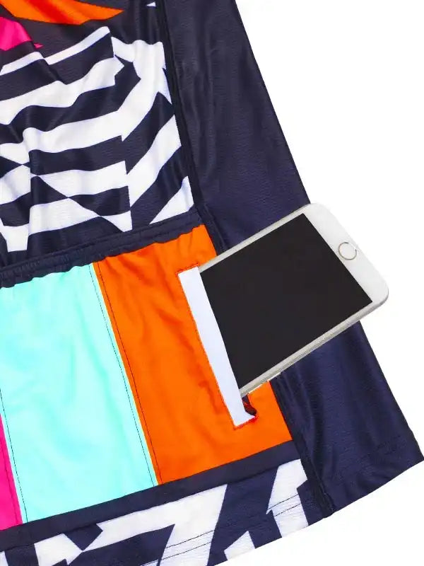 Colorful cycling shorts with phone pocket, geometric patterns, and vibrant panels for active riders.