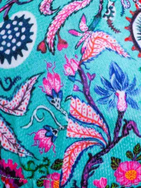 Vibrant floral cycling jersey with pink, blue, and teal botanical print on performance fabric