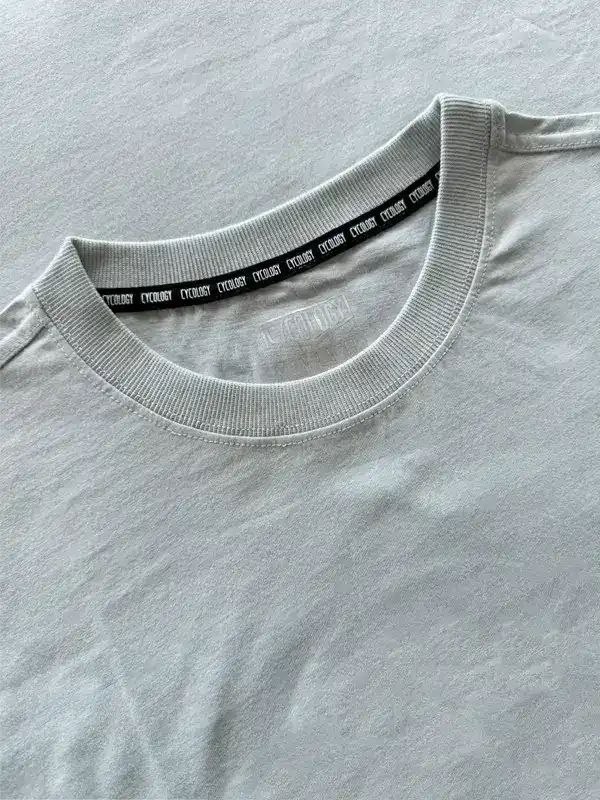 Light gray cycling t-shirt with branded neck tape, soft fabric detail for comfort and style.