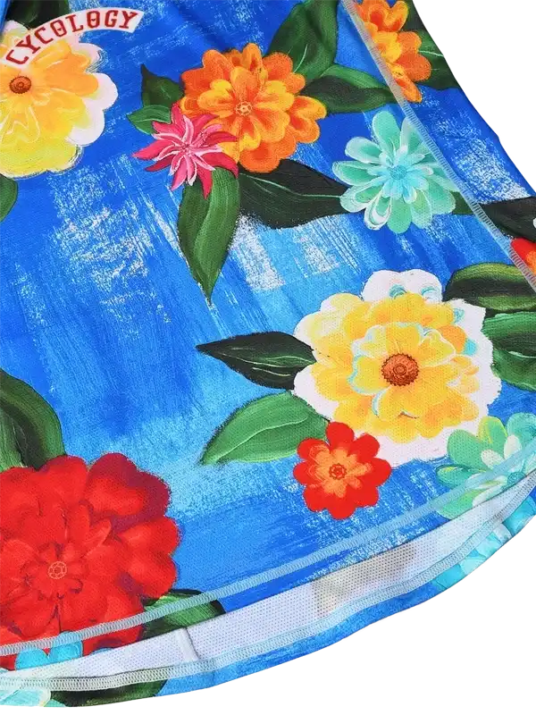 Vibrant floral cycling apparel with bold blue background and colorful blooms