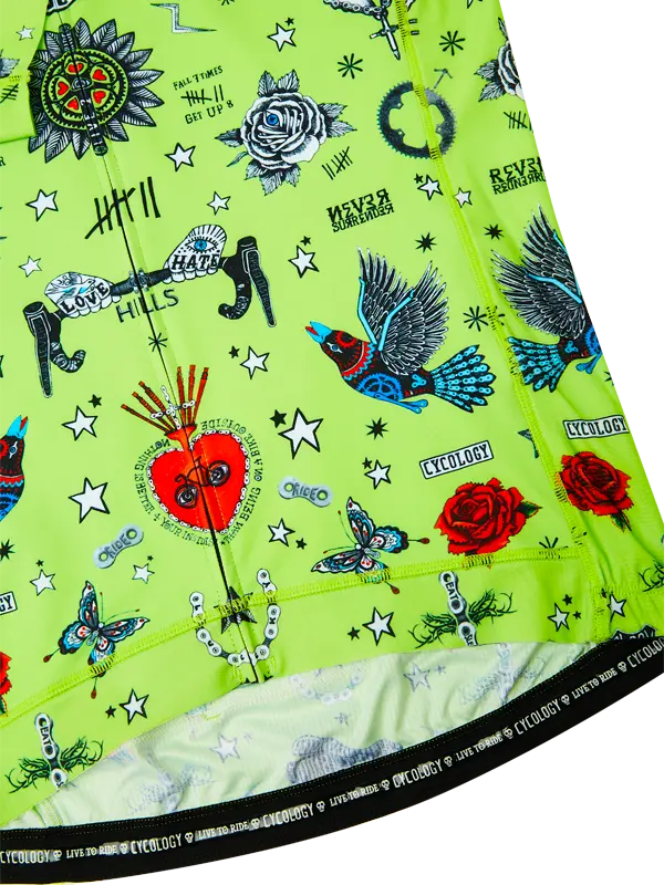 Close-up of a green fabric with colorful graphic designs on a white background