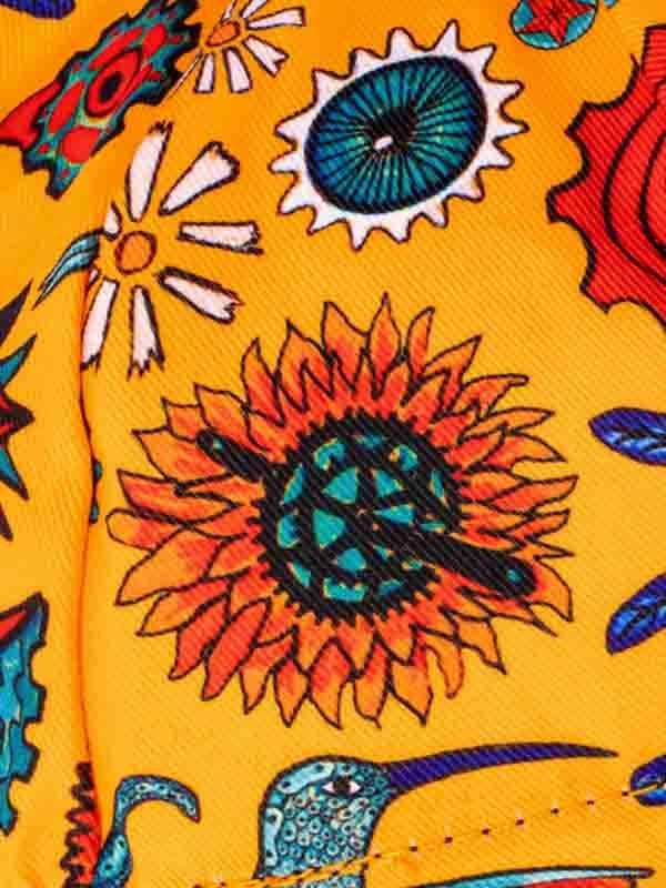 Vibrant yellow cycling jersey with sunflower, gear, and hummingbird print design