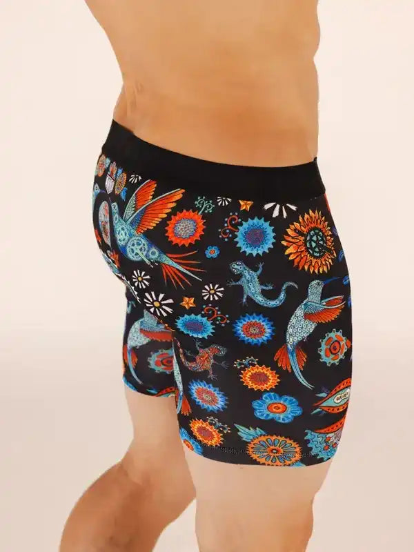 Men's cycling shorts with vibrant bird and floral print on black fabric, ideal for active wear.