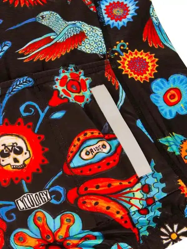 Vibrant cycling shorts with hummingbird, skull, and floral print on black fabric