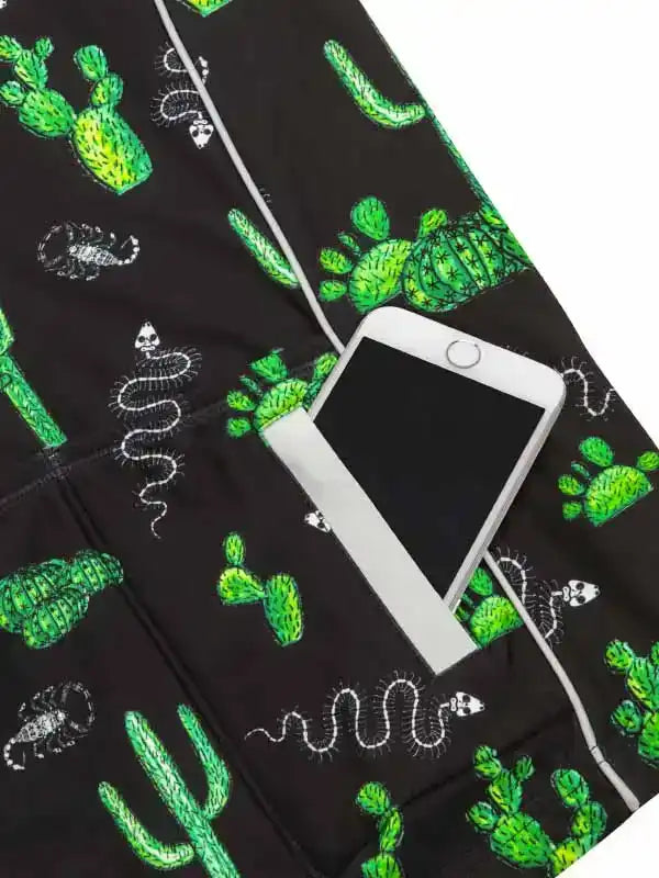 Black cycling shorts with green cactus and snake print, featuring phone pocket for on-the-go convenience