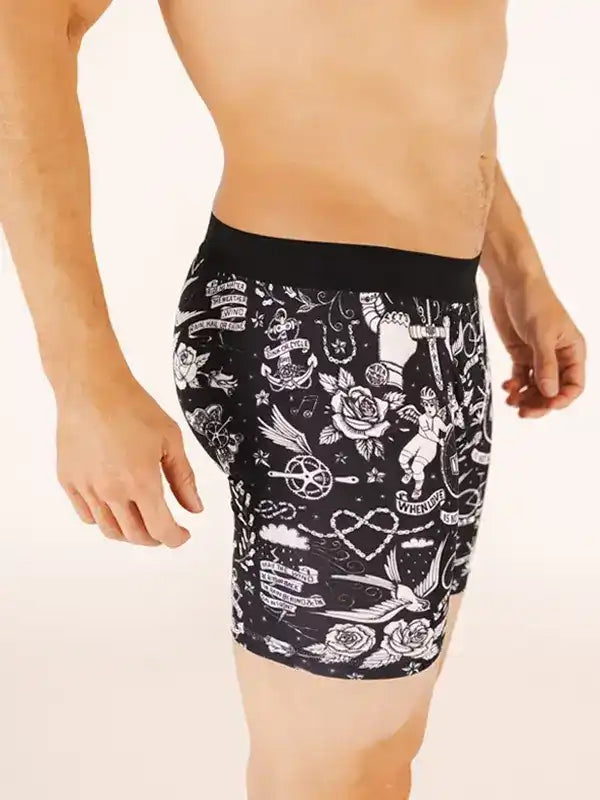 Men's cycling shorts with black and white tattoo-style print, featuring roses, anchors, and vintage designs.