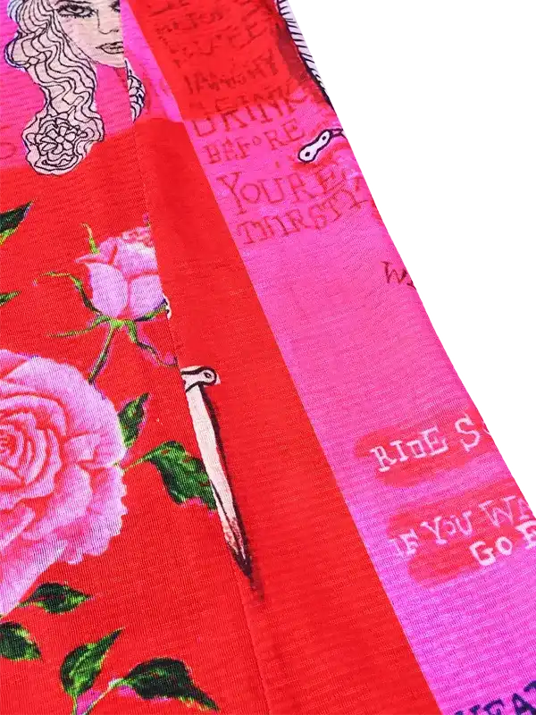 Vibrant red cycling jersey with pink roses, green leaves, and bold text design for women's bike wear