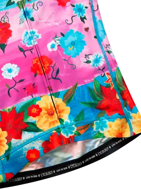 Vibrant floral cycling shorts with pink, blue, and red blooms, featuring 'CYCOLOGY LIVE TO RIDE' waistband