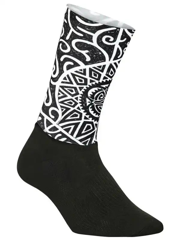 Black cycling sock with bold white tribal pattern, designed for comfort and style on rides.