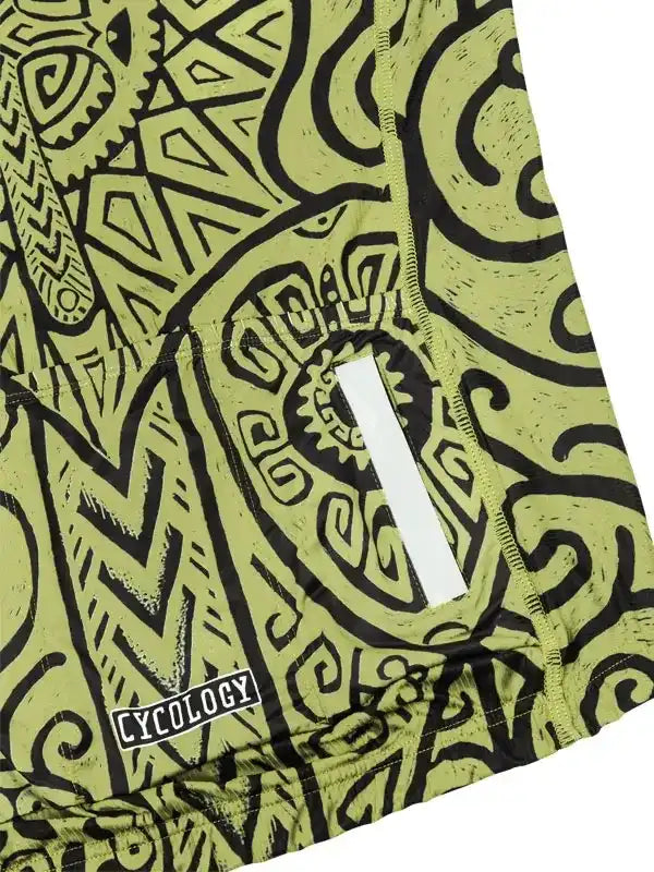 Men's cycling shorts with bold green and black tribal print, featuring reflective strip and Cycology logo