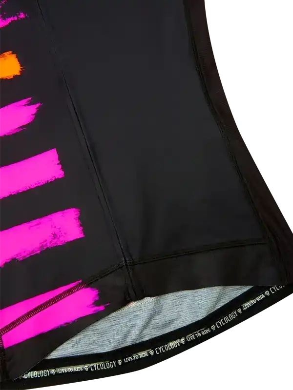 Black cycling shorts with vibrant pink and orange brushstroke design, featuring 'CYCOLOGY LIVE TO RIDE' waistband