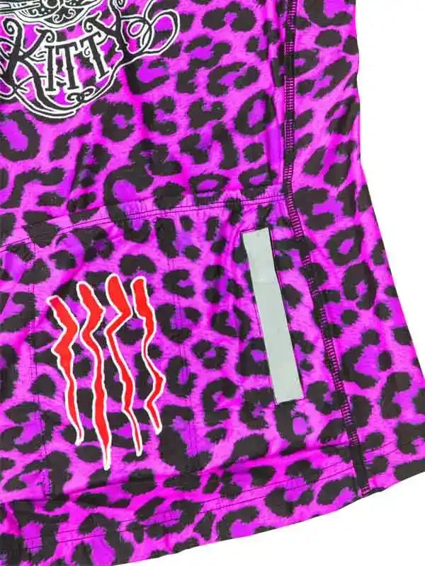 Vibrant pink leopard print cycling jersey with bold graphic design and reflective strip