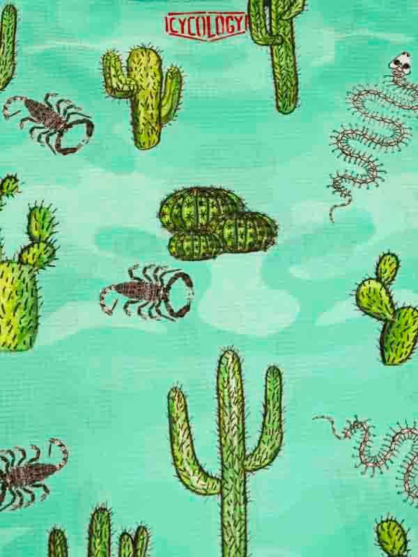 Desert-themed cycling fabric with cacti, scorpions, snakes on teal background, ideal for unique bike apparel