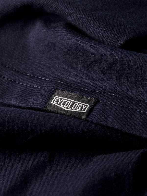 Cycology brand tag on dark navy cycling apparel fabric, showcasing quality stitching and design detail