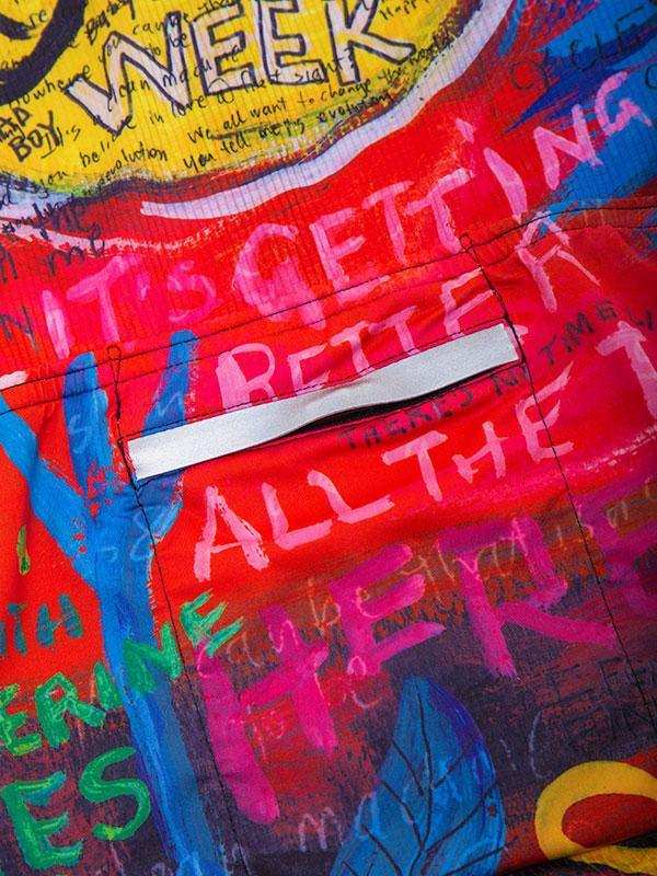 Vibrant cycling jersey with bold graffiti-style text and colorful abstract art design