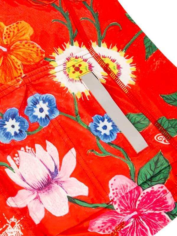Vibrant red cycling shorts with tropical floral print, featuring hibiscus and lotus designs for women's bike wear.